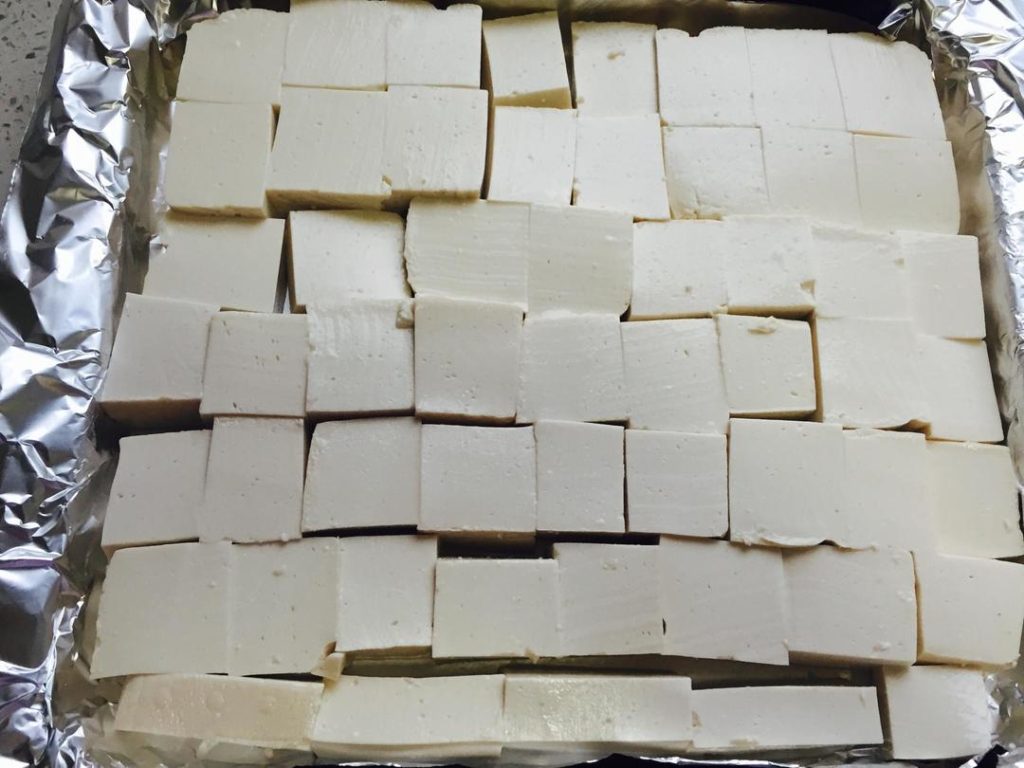 Arrange the Tofu Preheat your oven to 356°F (180°C). Line a baking sheet with parchment paper. Place the tofu slices on the sheet.