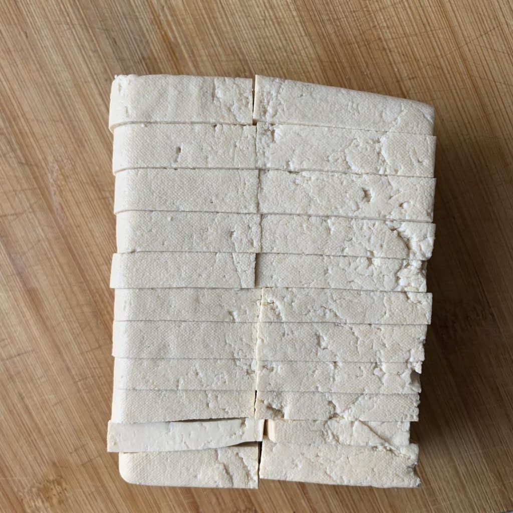 Cut the tofu into rectangular slices, about 1/3 inch (0.8 cm) thick