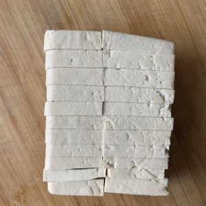 Cut the tofu into rectangular slices, about 1/3 inch (0.8 cm) thick