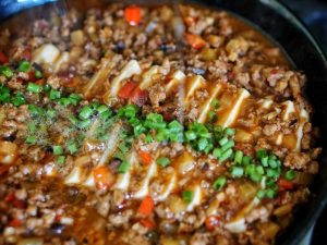 The Hot Oil Flash Sprinkle the Sichuan peppercorn powder and chopped scallions on top.