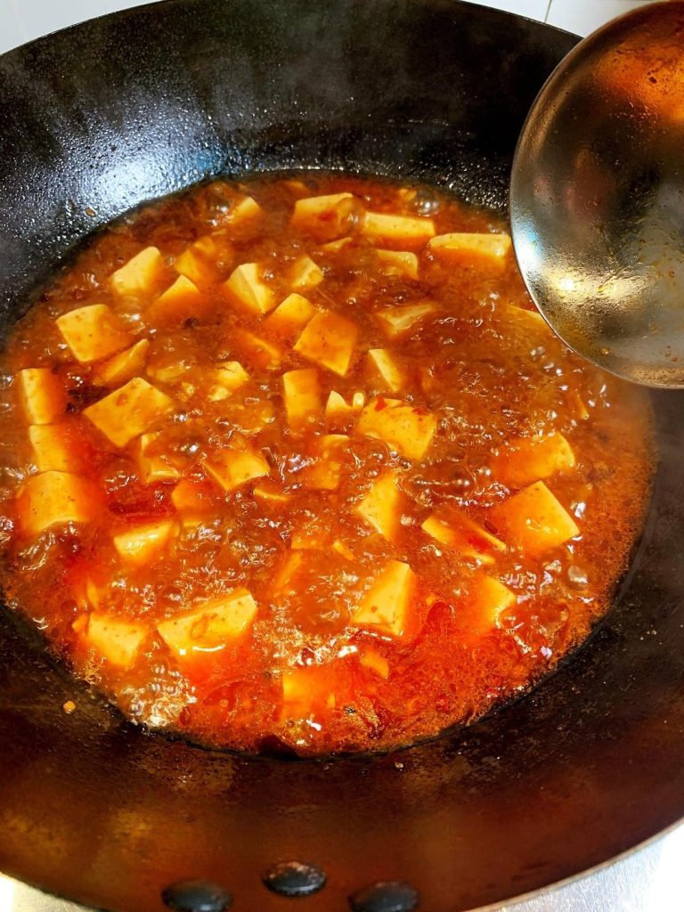 Braise the Tofu Gently drain your blanched tofu and slide it into the bubbling sauce.