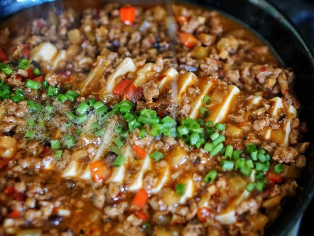 The Hot Oil Flash Sprinkle the Sichuan peppercorn powder and chopped scallions on top.