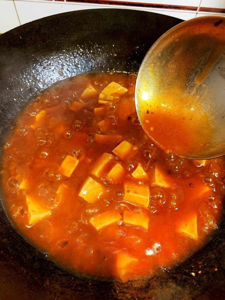The Three-Stage Thickening (Important!) Remove the lid. Turn the heat up slightly. We will add the starch water in three separate batches