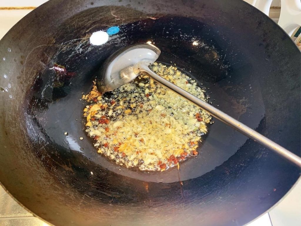 Fry the Aromatics Heat your wok over medium-low heat.