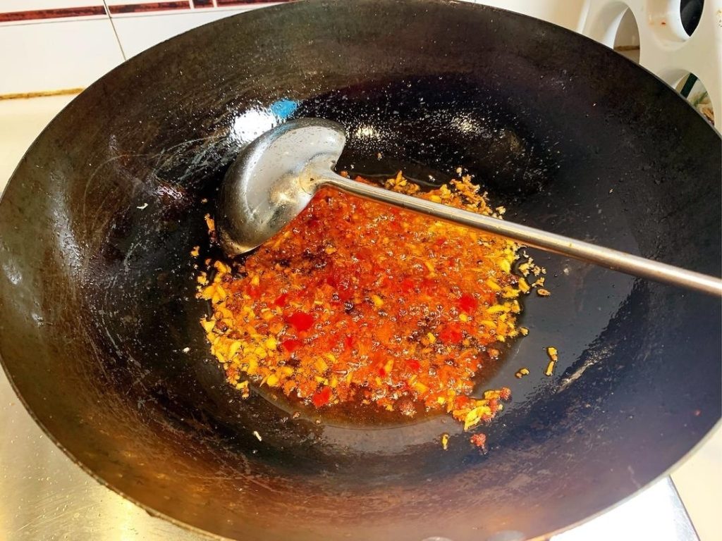 Create the Red Oil Add 2 tablespoons of Doubanjiang to the oil.