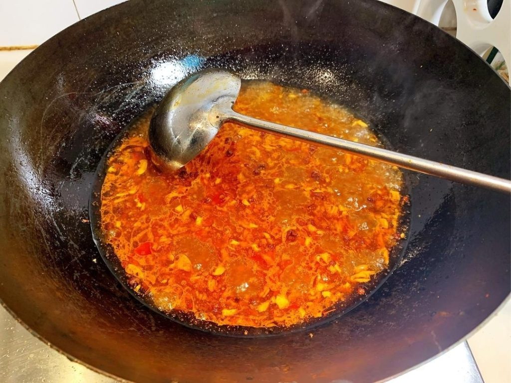 Create the Red Oil Add 2 tablespoons of Doubanjiang to the oil.