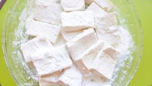 Slice the tofu and coat each piece in a thin layer of cornstarch.