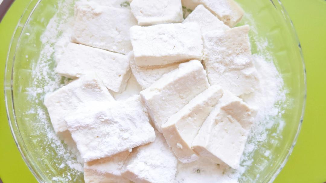 Slice the tofu and coat each piece in a thin layer of cornstarch.