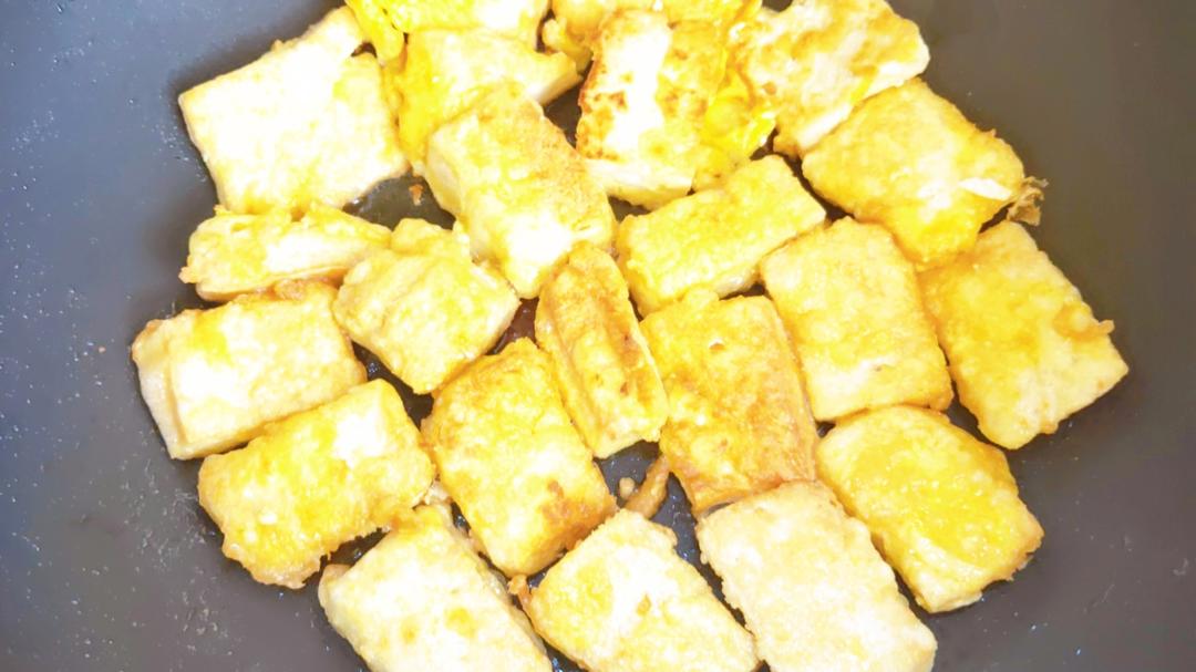 Fry until both sides of the tofu are golden and crisp.