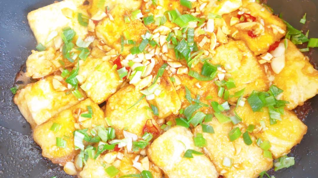 Scatter sliced scallions over the glazed tofu.