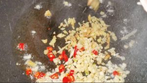 Bloom the ginger, garlic, and chili in hot oi