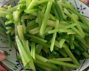 Wash the celery and cut it on the bias
