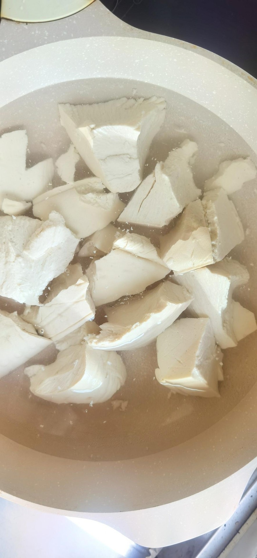 Bring salted water to a boil; break the tofu