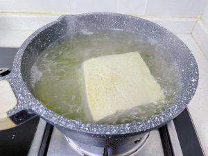 After thawing, boil the tofu 2-3 minutes to l