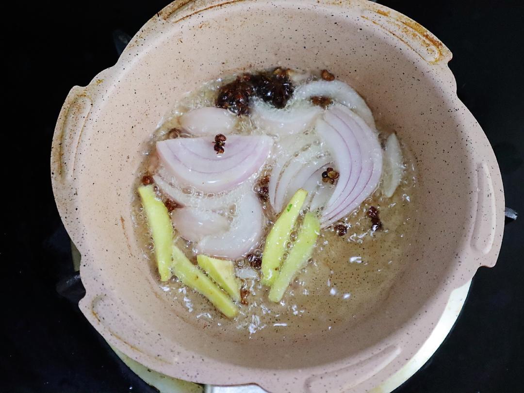 Heat corn oil with onion, ginger, peppercorns