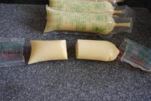 Cut the tofu tube (packaging and all) in the