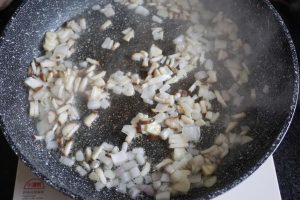 Add the onion and shiitake and toss until fra