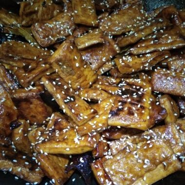 Caramel-glazed dried tofu tossed with cumin and sesame