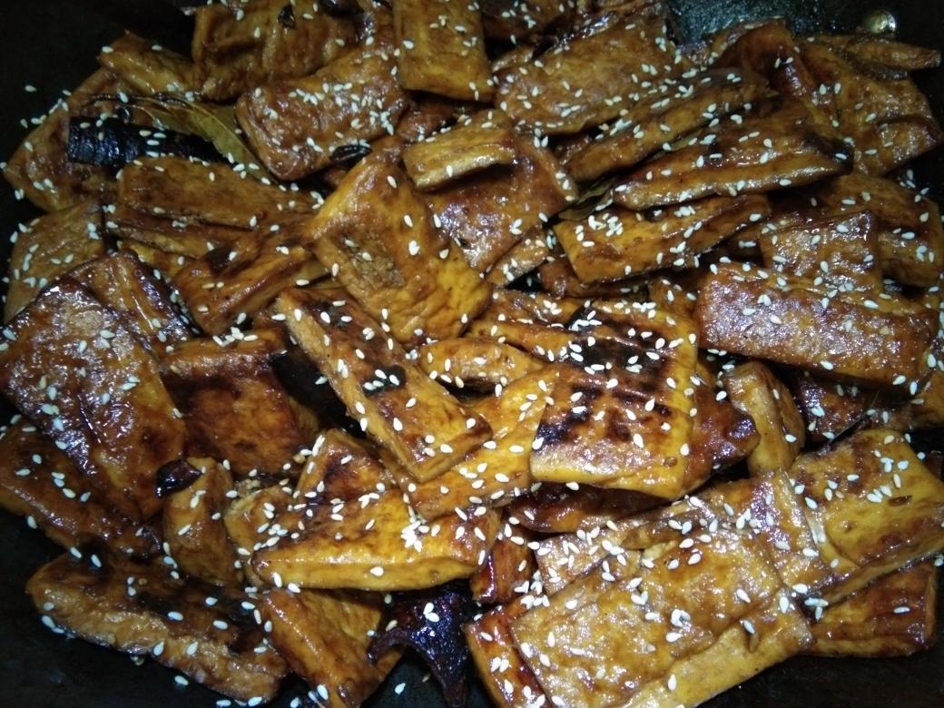 Caramel-glazed dried tofu tossed with cumin and sesame