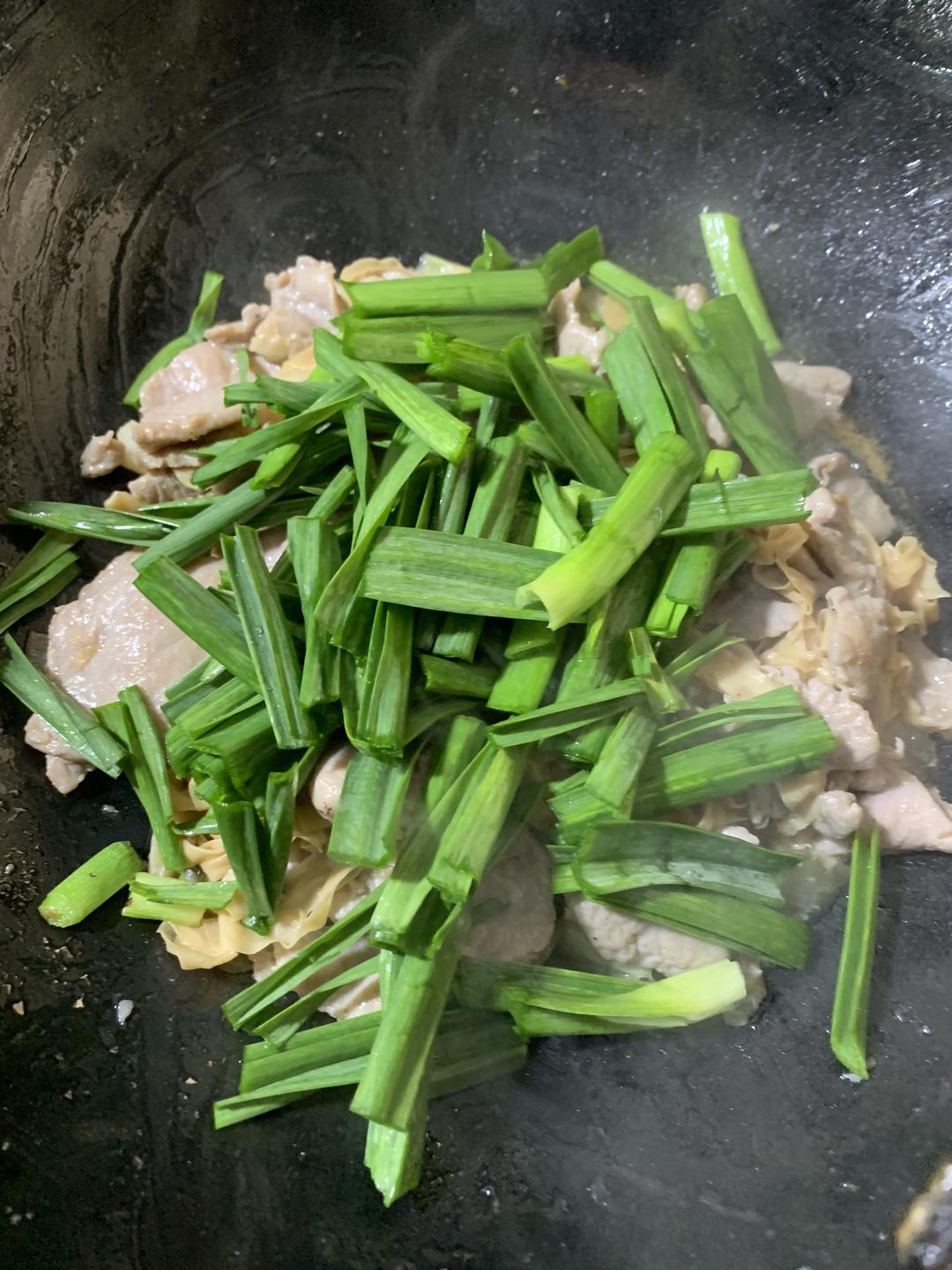 Return the pork and add the garlic-scape gree