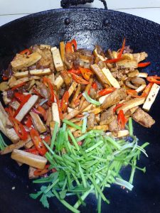 Add the celery and toss 1 minute