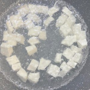 Blanch the tofu cubes for 30 seconds