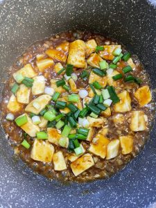 Scatter scallion over the glazed tofu