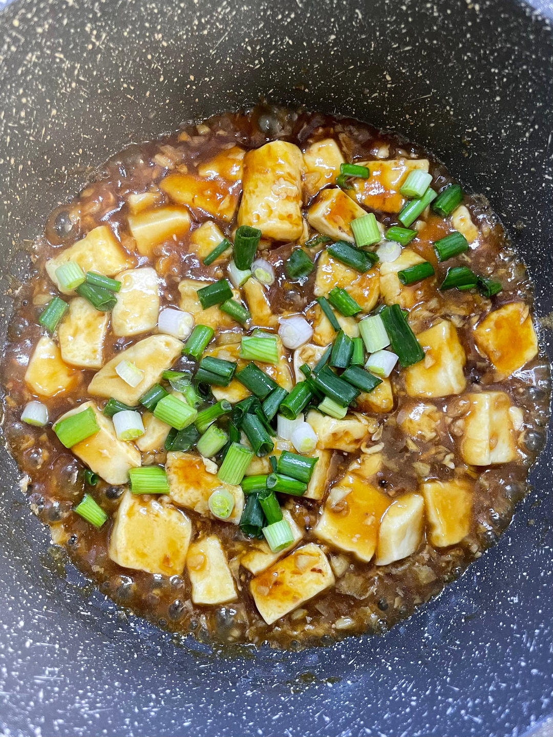 Scatter scallion over the glazed tofu
