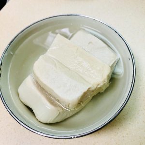 Rinse the silken tofu, drain and seal it, and