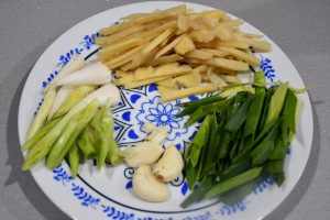 Flatten the garlic white and cut it on the bi