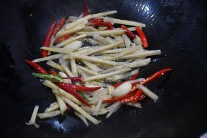 Heat oil and bloom the garlic, pickled ginger