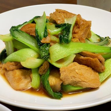 Brown-sealed frozen tofu with greens in a light stock