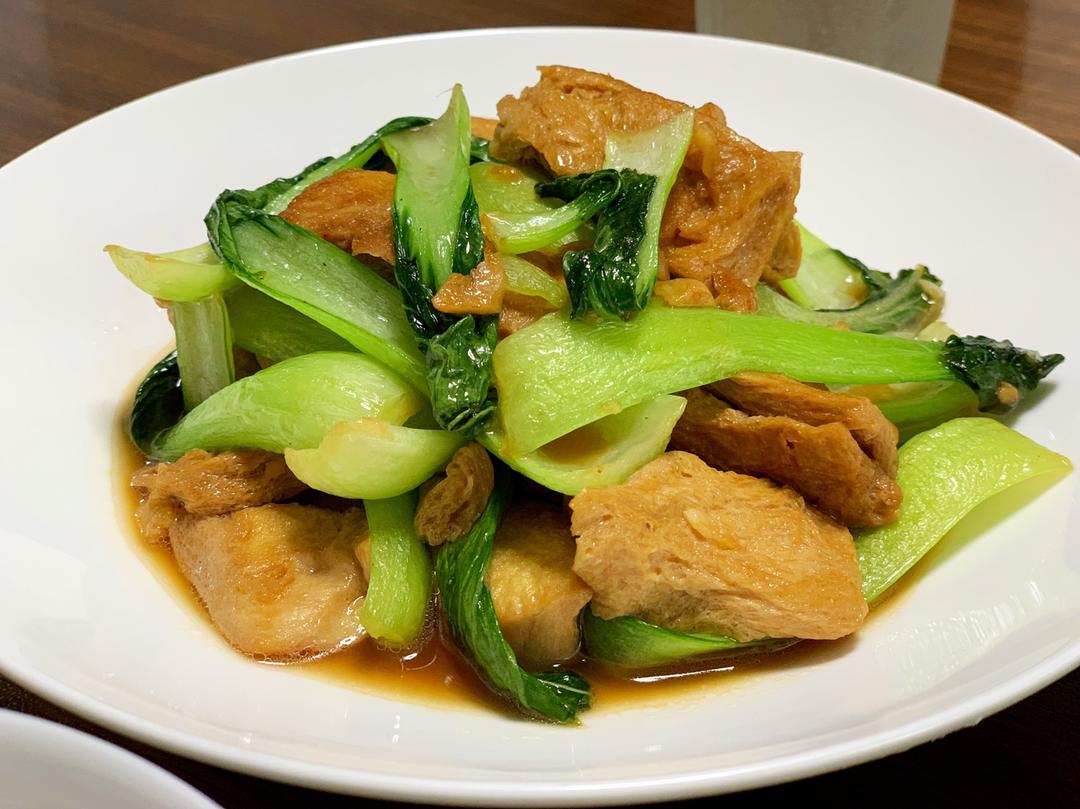 Brown-sealed frozen tofu with greens in a light stock