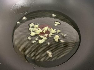 Heat oil and bloom the garlic until fragrant
