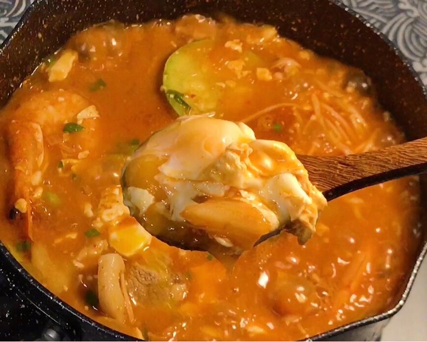 Red Korean stew with a whole box of silken tofu and an egg