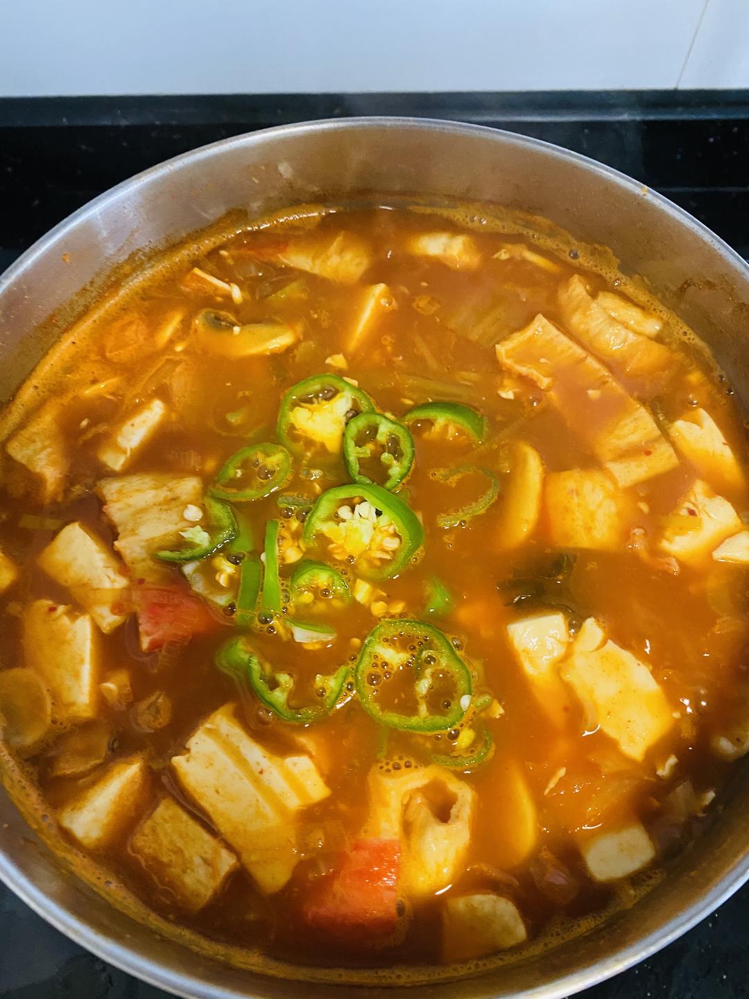 When the tofu is cooked, add the green chili