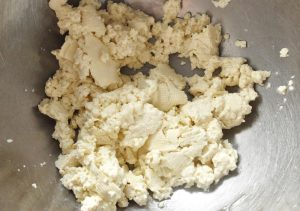 Drain the tofu and mash it to crumbs by hand