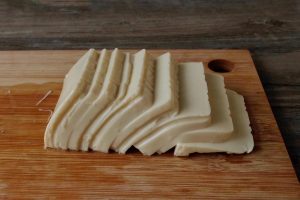 For one serving, slice half the tofu thin