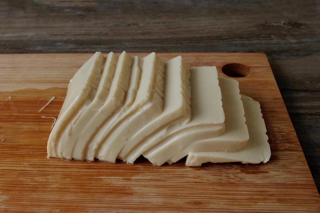 For one serving, slice half the tofu thin