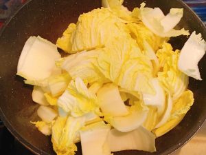Heat oil and stir-fry the cabbage until soft