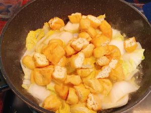 Add the halved tofu puffs