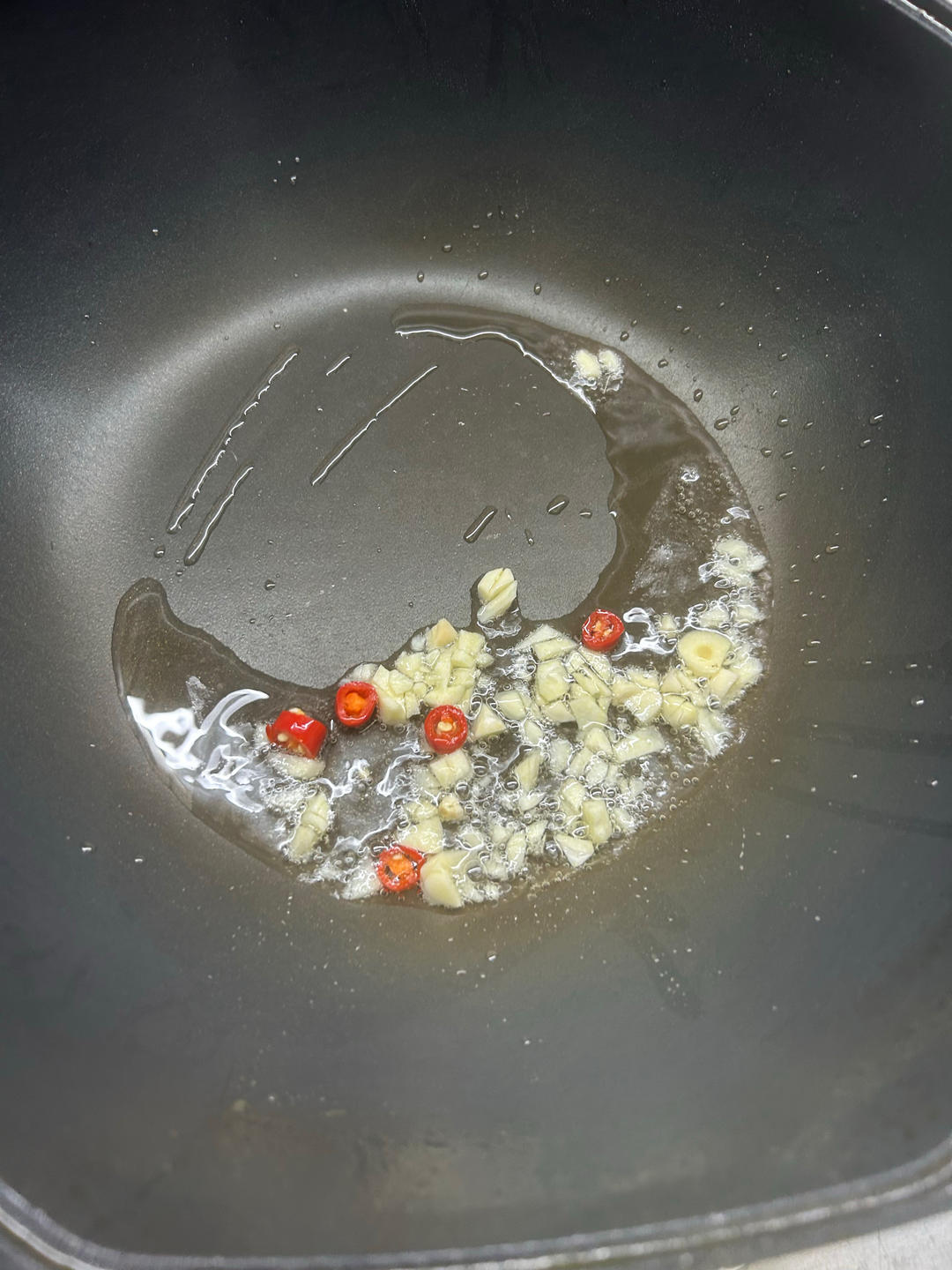 Bloom the garlic and chili in hot oil until f