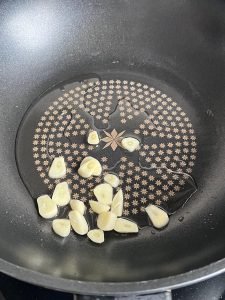Add a little oil and bloom the garlic