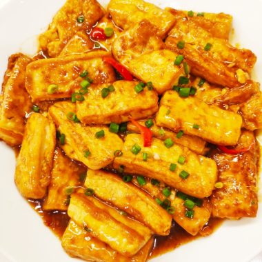 Golden egg-coated tofu in a glossy soy glaze