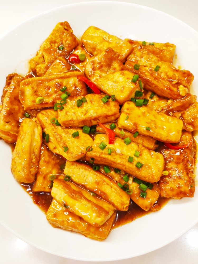 Golden egg-coated tofu in a glossy soy glaze