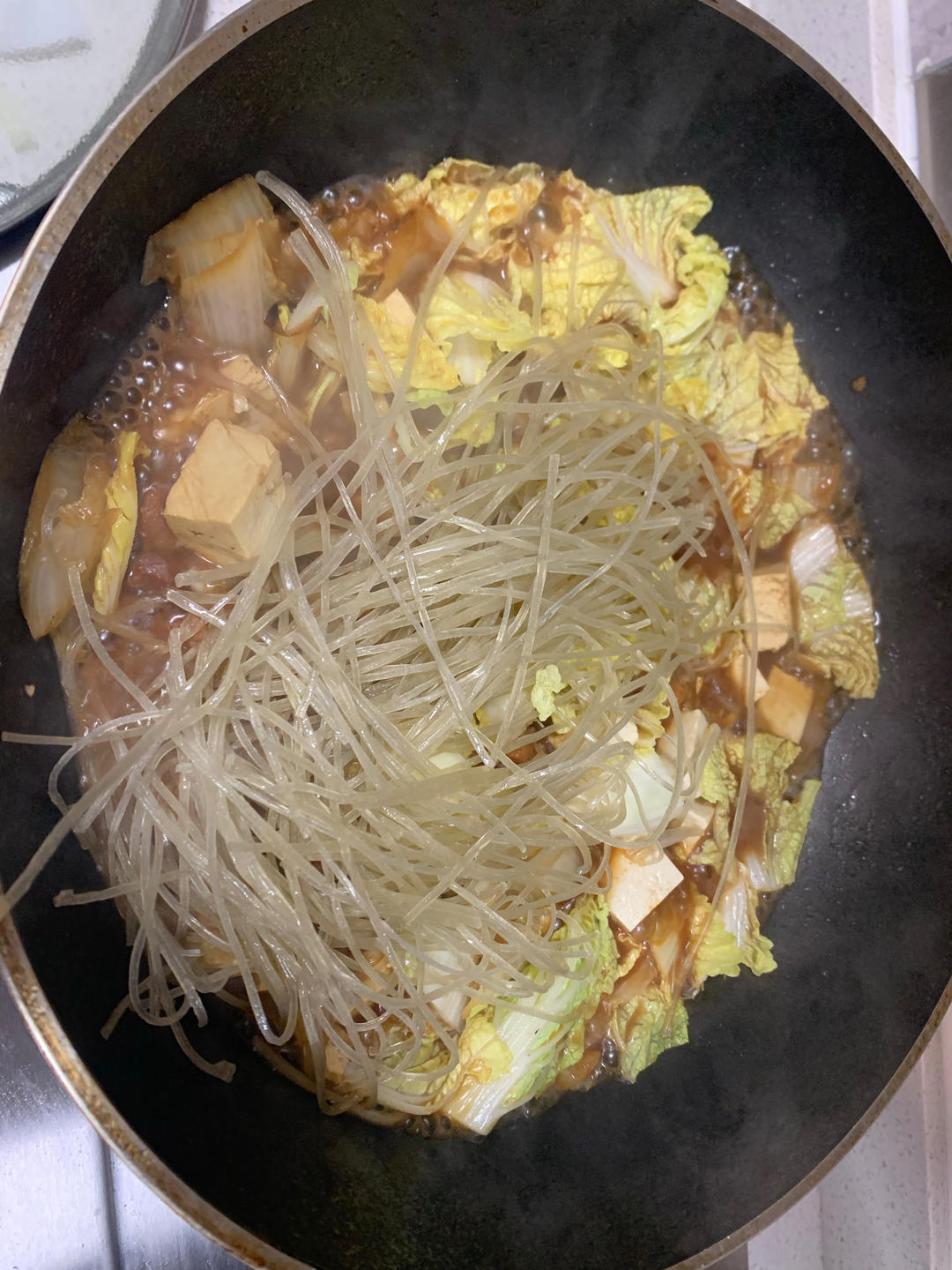 Add the cabbage leaves, sweet-potato noodles,