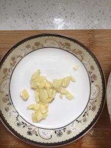 Smash a clove of garlic with the blade and mi