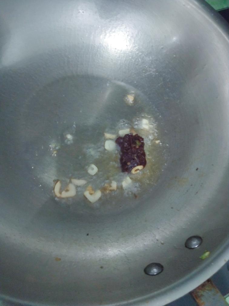 Heat oil, add the garlic and the doubanjiang