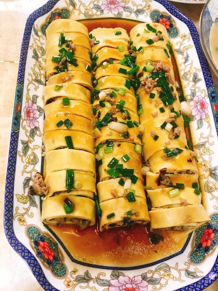 Sliced tofu-skin pork rolls glazed on a plate