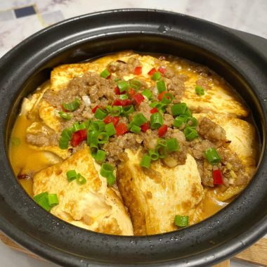 Golden tofu braised under seasoned pork in a sand pot